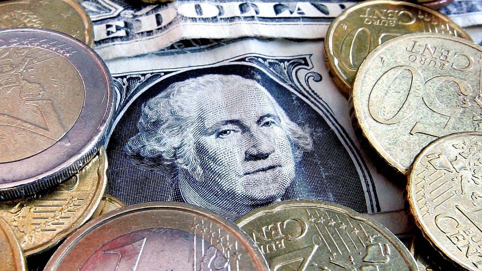 Euro coins and dollar bills are seen in Frankfurt, central Germany.