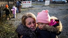 Svetlana Titova, 52, hugs her granddaughter as they arrive from the Russian-held town of Berdyansk, November 7, 2022.