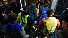 Volunteers and paramedics carry an elderly evacuee from Kherson into a hall on Nov. 10th 2022