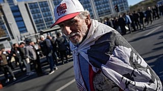 A supporter of Istanbul Mayor Ekrem Imamoglu, demonstrates in front of Anadolu courthouse in Istanbul, Turkey, Friday, Nov. 11, 2022.