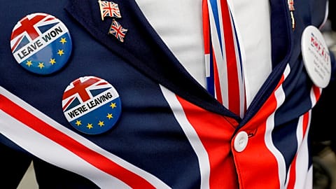 Pro-Brexit supporter wears badges as he demonstrates outside Parliament in London, Oct. 28, 2019. 