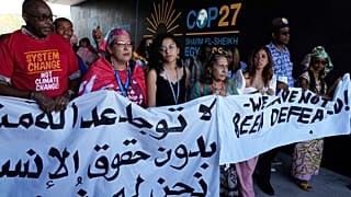 Sanaa Seif, center, sister of Egypt's jailed leading pro-democracy activist Alaa Abdel-Fattah, who is on a hunger and water strike, attends a protest with others at COP27.