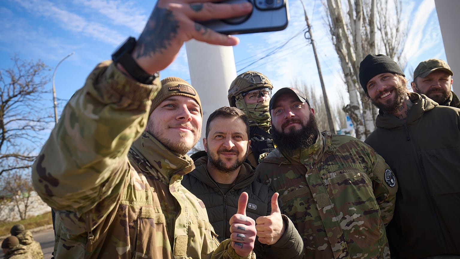 Ukrainian soldiers take a selfie with President Volodymyr Zelenskyy during his visit to Kherson.