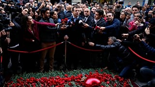 Ekrem  Imamoglu, mayor of Istanbul, speaking to press with mourners as after blast attack 