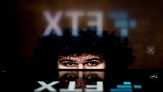 This photo illustration shows the logo of cryptocurrency FTX, reflected in an image of former chief executive Samuel Bankman-Fried, in Washington, DC, on November 13, 2022.
