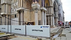 Newly-installed glass barriers have managed to keep a high tide from flooding Venice’s ancient basilica. 