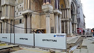 Newly-installed glass barriers have managed to keep a high tide from flooding Venice’s ancient basilica.