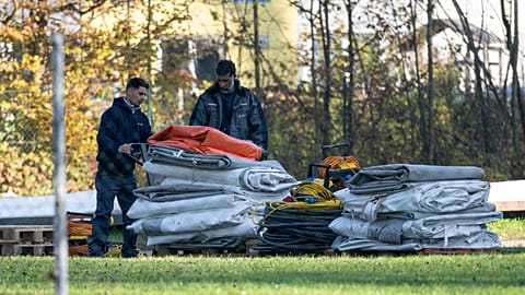 Two men dismantle tents tents that were set up as shelters for refugees in St. Georgen im Attergau, Austria, Monday, Nov. 14, 2022. 