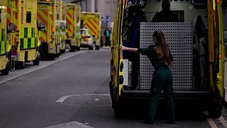A paramedic opens the doors of an ambulance to take a patient into the Royal London Hospital in the Whitechapel area of east London,.