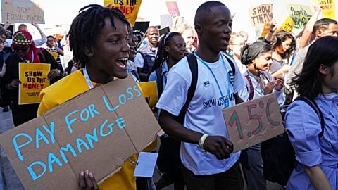Vanessa Nakate, of Uganda, left, participates in a Fridays for Future protest at COP27.