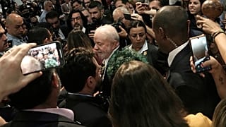 Brazilian President-elect Luiz Inacio Lula da Silva, center, leaves after speaking at COP27.