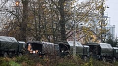 Polish soldiers unload equipment from their trucks, near where a missile struck killing two people on farmland at Przewodow, near the Ukraine border, Nov. 16, 2022.