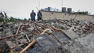 Kenyan police attend the scene of a building collapse in Ruaka, on the outskirts of the capital Nairobi.