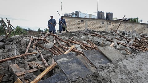 Kenyan police attend the scene of a building collapse in Ruaka, on the outskirts of the capital Nairobi.