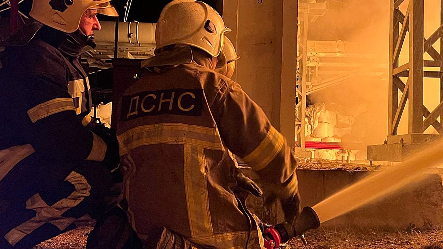 This photo taken on November 15, 2022 by Ukrainian Emergency Service, shows rescuers putting out a fire on critical infrastructure after missile strike to the Kyiv region.