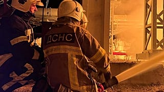 This photo taken on November 15, 2022 by Ukrainian Emergency Service, shows rescuers putting out a fire on critical infrastructure after missile strike to the Kyiv region.