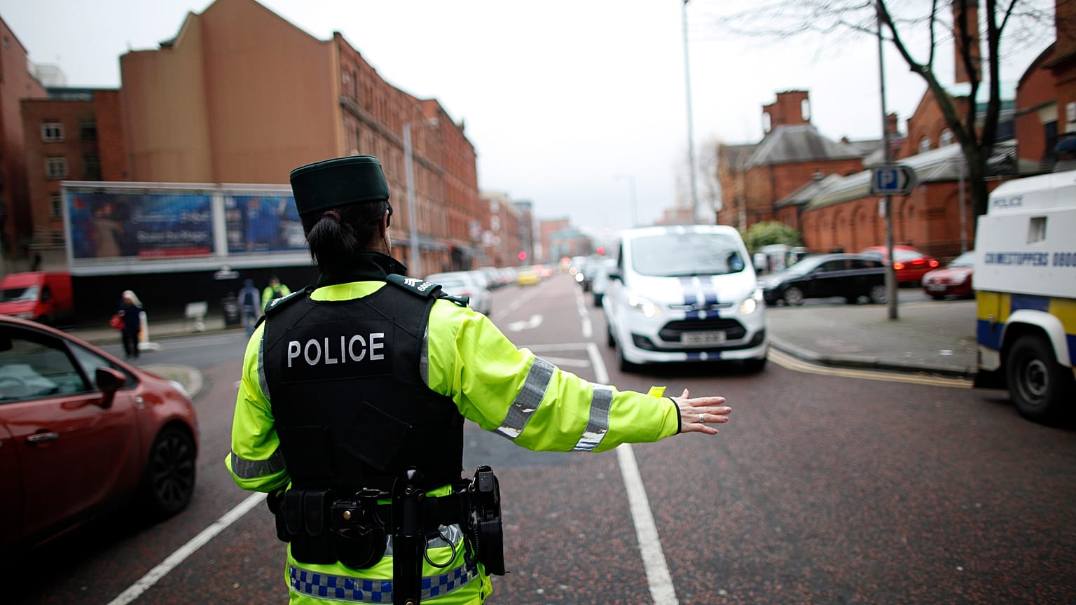 A police officer checks vehicles on the Ormeau Avenue in South Belfast, Northern Ireland,.