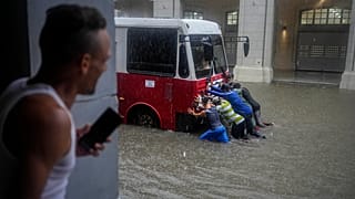 Volunteers helping bus get through floodwaters in Cuba's capital Havana. File photo.