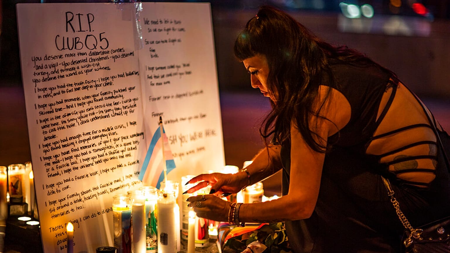 A mourner pays their respects at a makeshift memorial for the victims of the mass shooting at Club Q.
