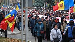 People march during a protest initiated by the populist Shor Party, calling for early elections and President Maia Sandu's resignation, in Chisinau, Moldova.