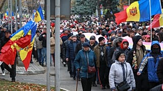 People march during a protest initiated by the populist Shor Party, calling for early elections and President Maia Sandu's resignation, in Chisinau, Moldova.