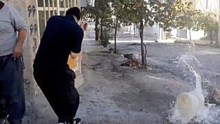 Un réservoir d'eau touché par une balle près d’un manifestant, lors d'une manifestation à Javanroud, une ville kurde de l'ouest de l'Iran