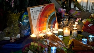 Candles stand near a sign with the names of victims of a weekend mass shooting during a vigil near the gay bar where the attack occurred. Monday, 21 November 2022,