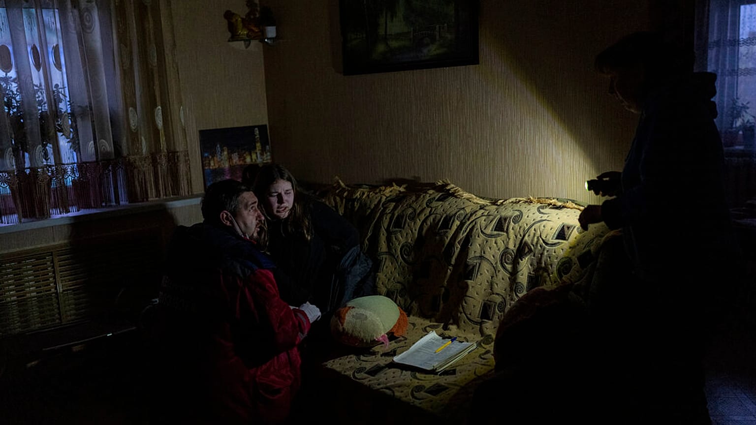 A Ukrainian paramedic treats a resident after a Russian attack in Kherson, southern Ukraine.