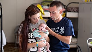 Antonina* and Andriy* with their baby premature Ganna* in a collective centre in Dnipro, eastern Ukraine.