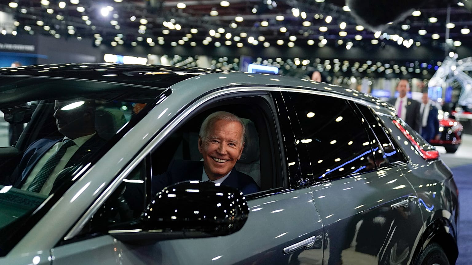 President Joe Biden drives a Cadillac Lyriq through the showroom during a tour at the Detroit Auto Show, Sept. 14, 2022, in Detroit.