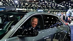 President Joe Biden drives a Cadillac Lyriq through the showroom during a tour at the Detroit Auto Show, Sept. 14, 2022, in Detroit.