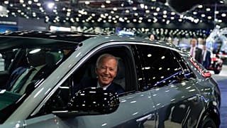 President Joe Biden drives a Cadillac Lyriq through the showroom during a tour at the Detroit Auto Show, Sept. 14, 2022, in Detroit.