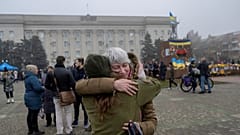 A woman hugs her friend who is a soldier in Ukraine army on November 21, 2022, in Kherson, amid the Russian invasion of Ukraine.