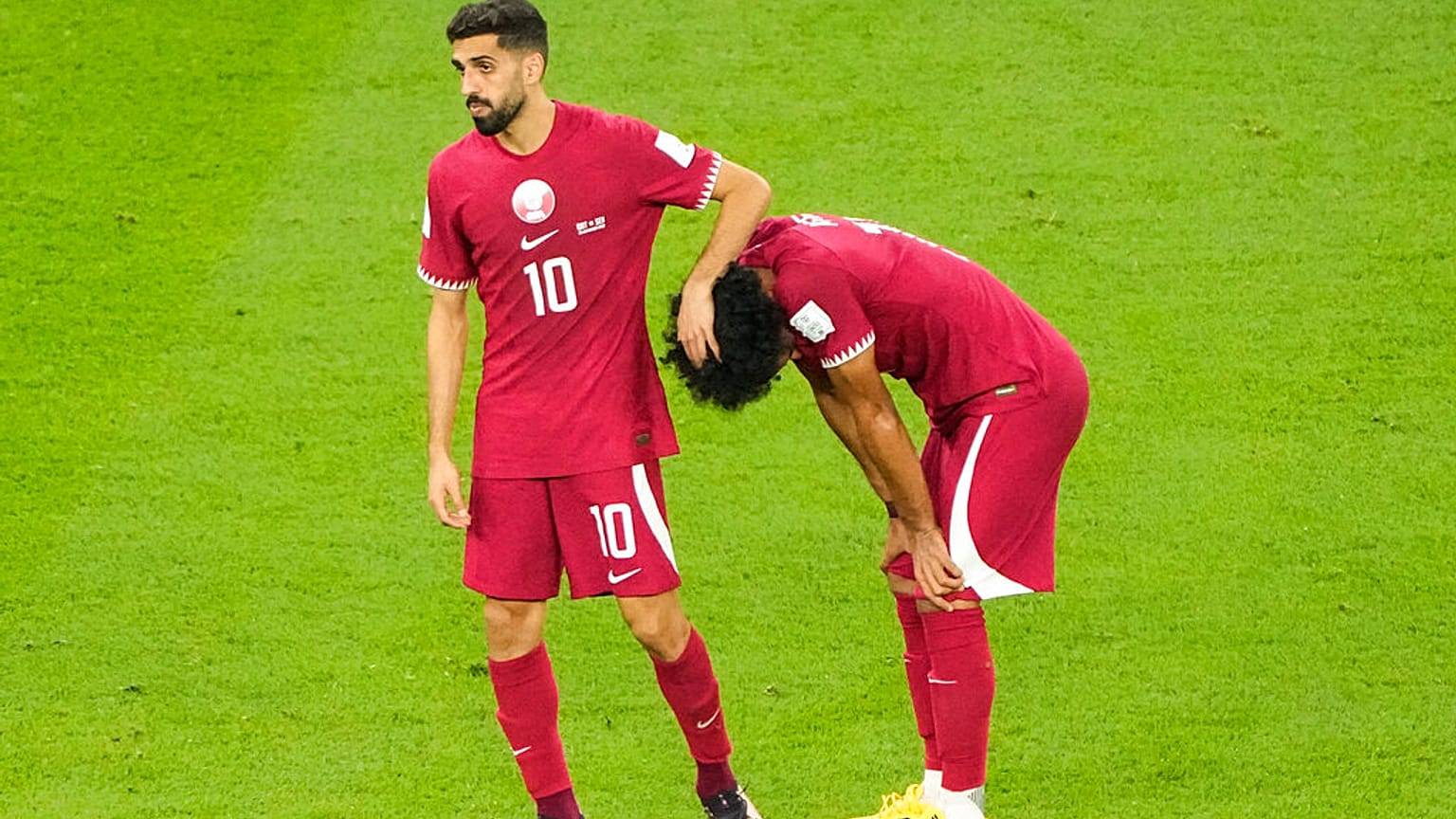 A katari Hassan Al-Haydos vigasztalja csapattársát, Akram Afifot