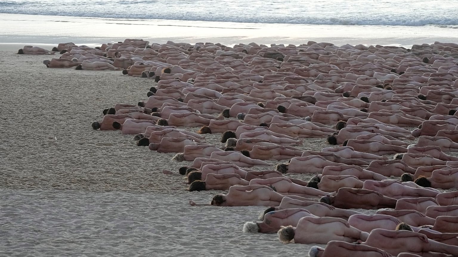 Hundreds of nude people pose for artist and photographer Spencer Tunick on Bondi Beach in Sydney, Saturday, Nov. 26, 2022. 