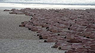 Hundreds of nude people pose for artist and photographer Spencer Tunick on Bondi Beach in Sydney, Saturday, Nov. 26, 2022.