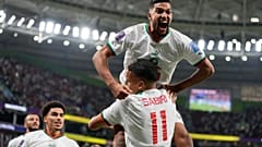 Morocco's Yahya Jabrane, top, celebrates with Abdelhamid Sabiri (11) after Sabiri scored during the World Cup match against Belgium in Doha, Nov. 27, 2022.