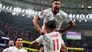 Morocco's Yahya Jabrane, top, celebrates with Abdelhamid Sabiri (11) after Sabiri scored during the World Cup match against Belgium in Doha, Nov. 27, 2022.