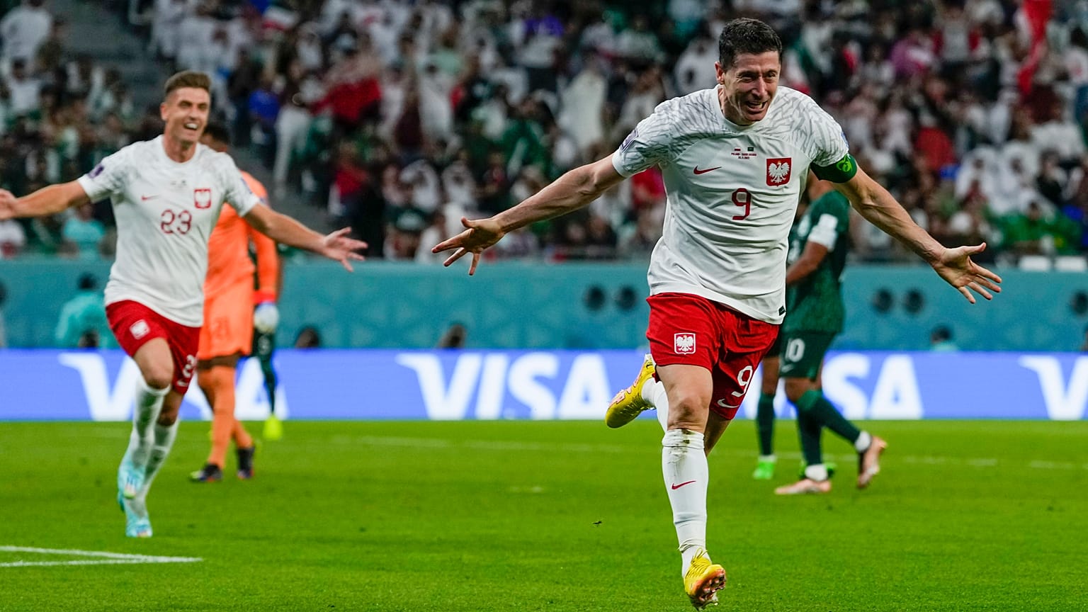 Poland's Robert Lewandowski celebrates scoring his side's 2nd goal during the World Cup group C match against Saudi Arabia in Al Rayyan , Qatar, Saturday, Nov. 26, 2022.
