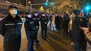 Police officers confront protestors in Shanghai on Nov. 27, 2022, scene of protests against China's zero-COVID policy.