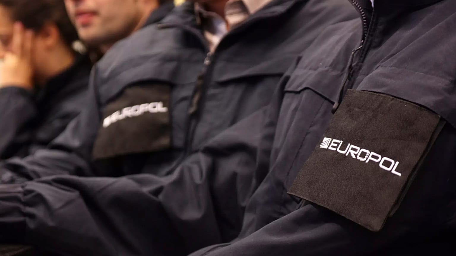 Operatives wearing uniforms with the logo of Europol