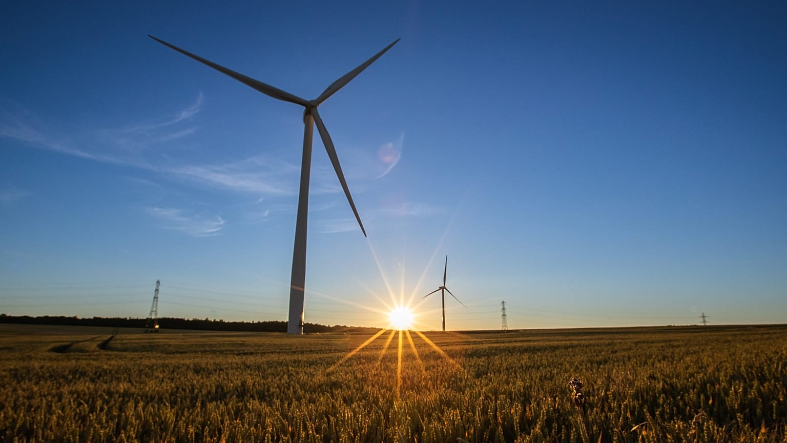 Wind turbines in operation as the sun sets over Hook Moor Wind Farm in Leeds, United Kingdom. 