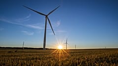 Wind turbines in operation as the sun sets over Hook Moor Wind Farm in Leeds, United Kingdom. 