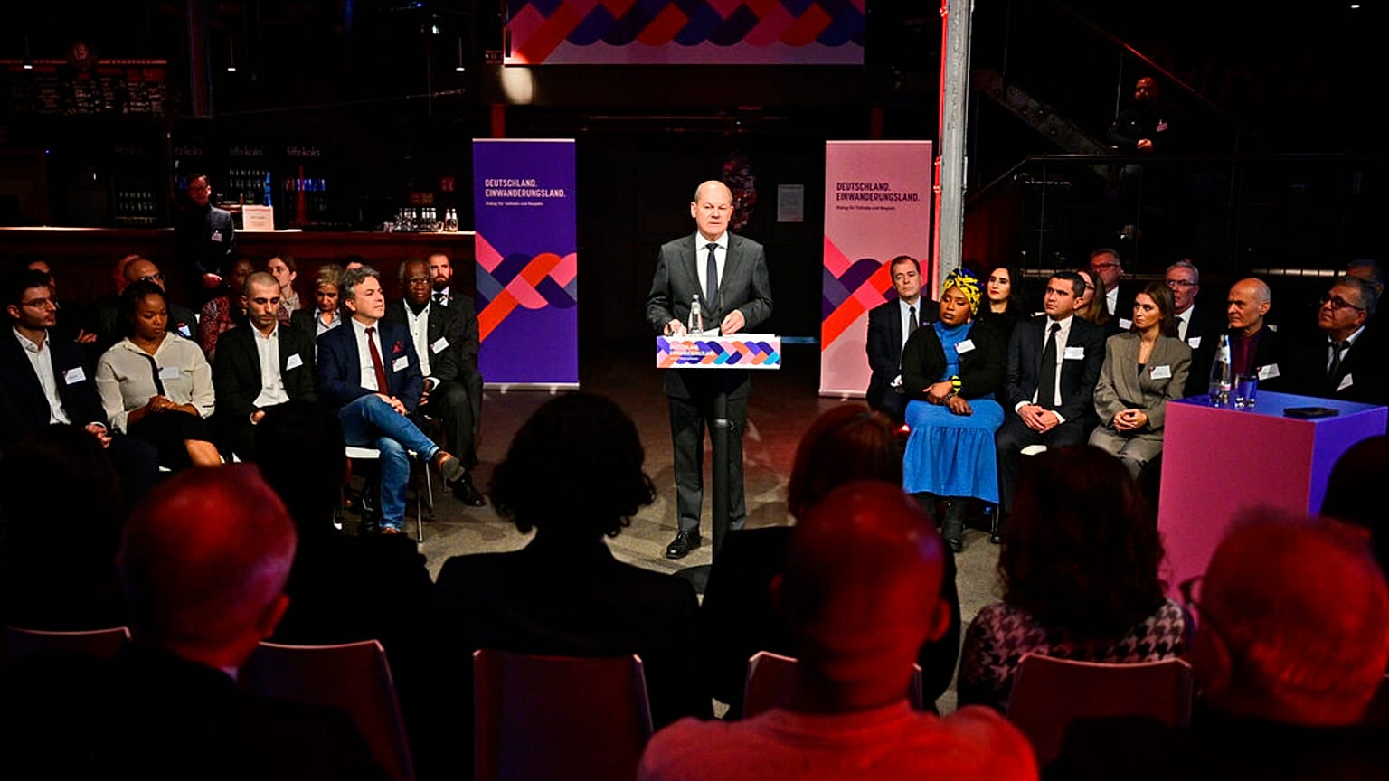 German Chancellor Olaf Scholz, centre, speaks during an immigration meeting "Germany, Immigration Country, Dialogue for Participation and Respect" in Berlin, Monday, Nov. 28, 