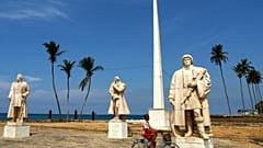 FILE: A boy rides his bicycle passed a colonial Portuguese statue at the coast of Sao Tome, Sao Tome and Principe, July, 22, 2005.