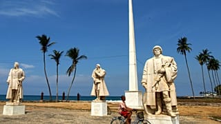 FILE: A boy rides his bicycle passed a colonial Portuguese statue at the coast of Sao Tome, Sao Tome and Principe, July, 22, 2005.