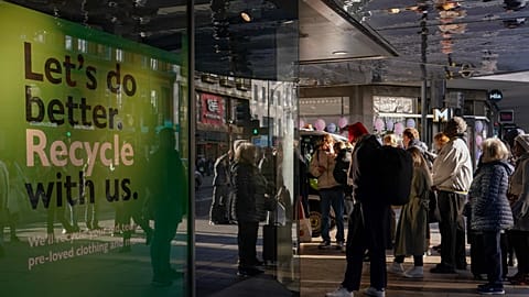 People queue outside a retail shop in Oxford Street on Black Friday, in London, Friday, Nov. 25, 2022.