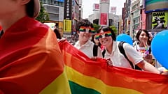 Participants smile as they march with a banner during the Tokyo Rainbow Pride parade celebrating the LGBT community in Tokyo.
