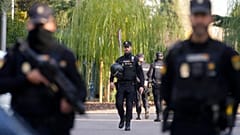 Police officers stand guard near the Ukrainian embassy, located in Madrid's Piovera neighbourhood.