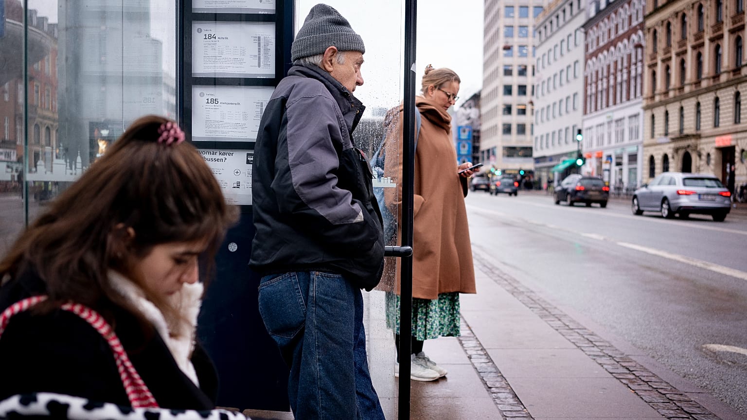 Passengers at a bus stop in Copenhagen, Denmark, Tuesday, Feb. 1, 2022. 